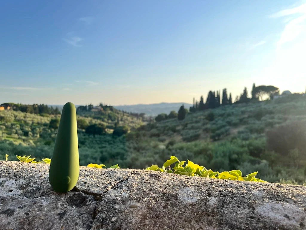 Green vibrator on background of Tuscan hills and cyrpesses